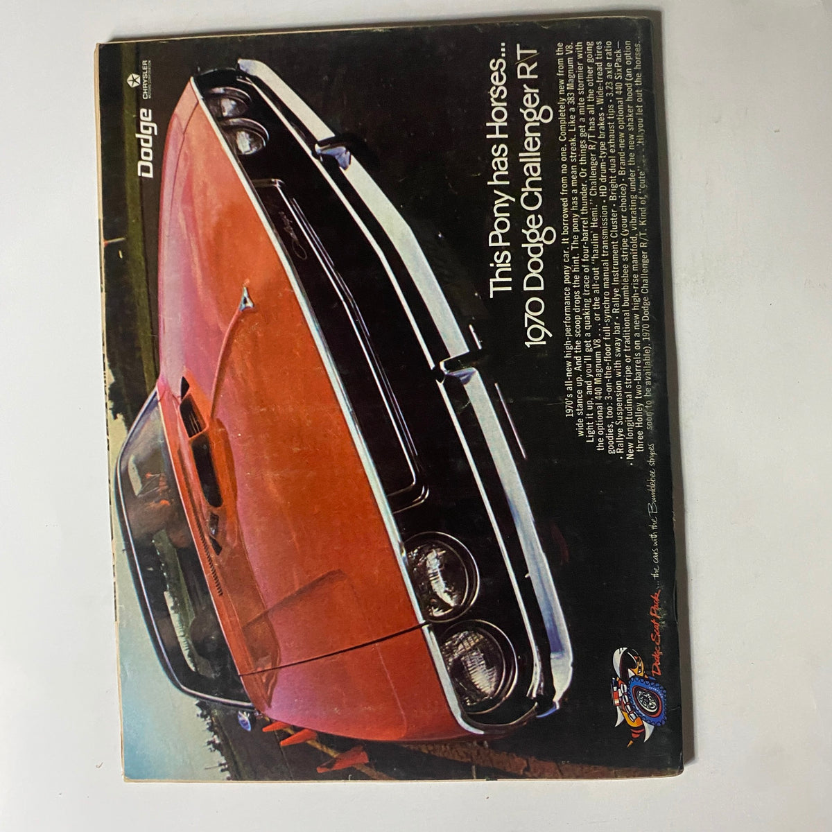 Back cover of VTG Car and Driver Magazine December 1969 displaying an advertisement for the 1970 Dodge Challenger RT, highlighting its powerful performance.