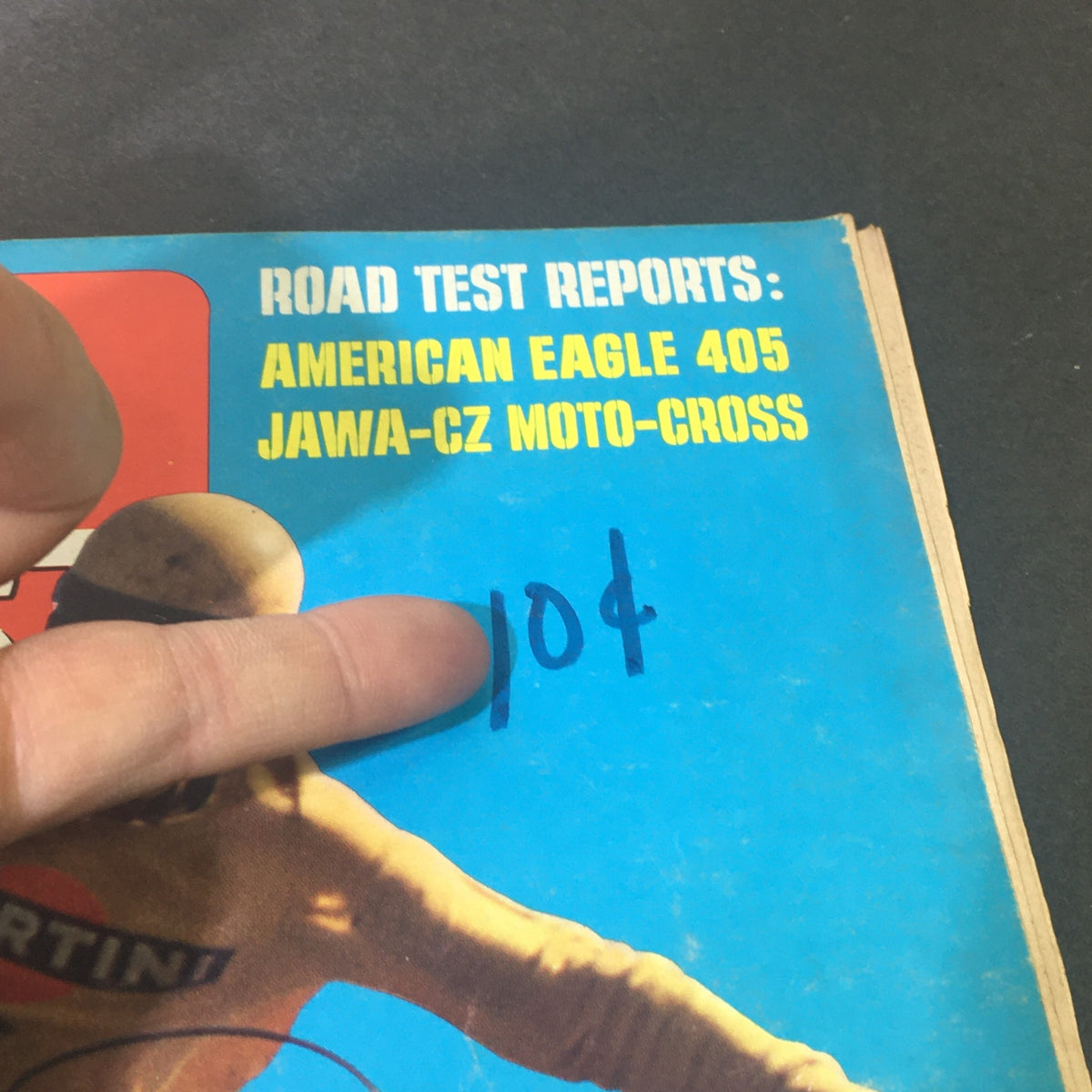 Close-up of the VTG Motor Cyclist Magazine December 1969 cover highlighting road test reports including American Eagle 405 and Jawa-CZ Moto-Cross, along with a handwritten price.