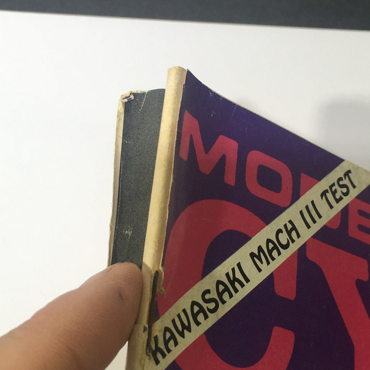 Close-up view of the spine of the VTG Modern Cycle Magazine June 1969, highlighting wear and tear typical for vintage publications.