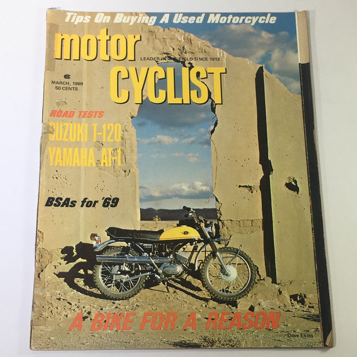 VTG Motor Cyclist Magazine March 1969 featuring a Suzuki T-120 and Yamaha AT-1 with a motorcycle displayed against a rugged landscape background.