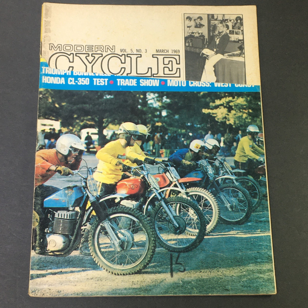 Cover of VTG Motor Cycle Magazine from March 1969 showcasing a test of the Honda CL-350 and the Triumph Bonneville, featuring colorful motorcycle racers lined up at an event.