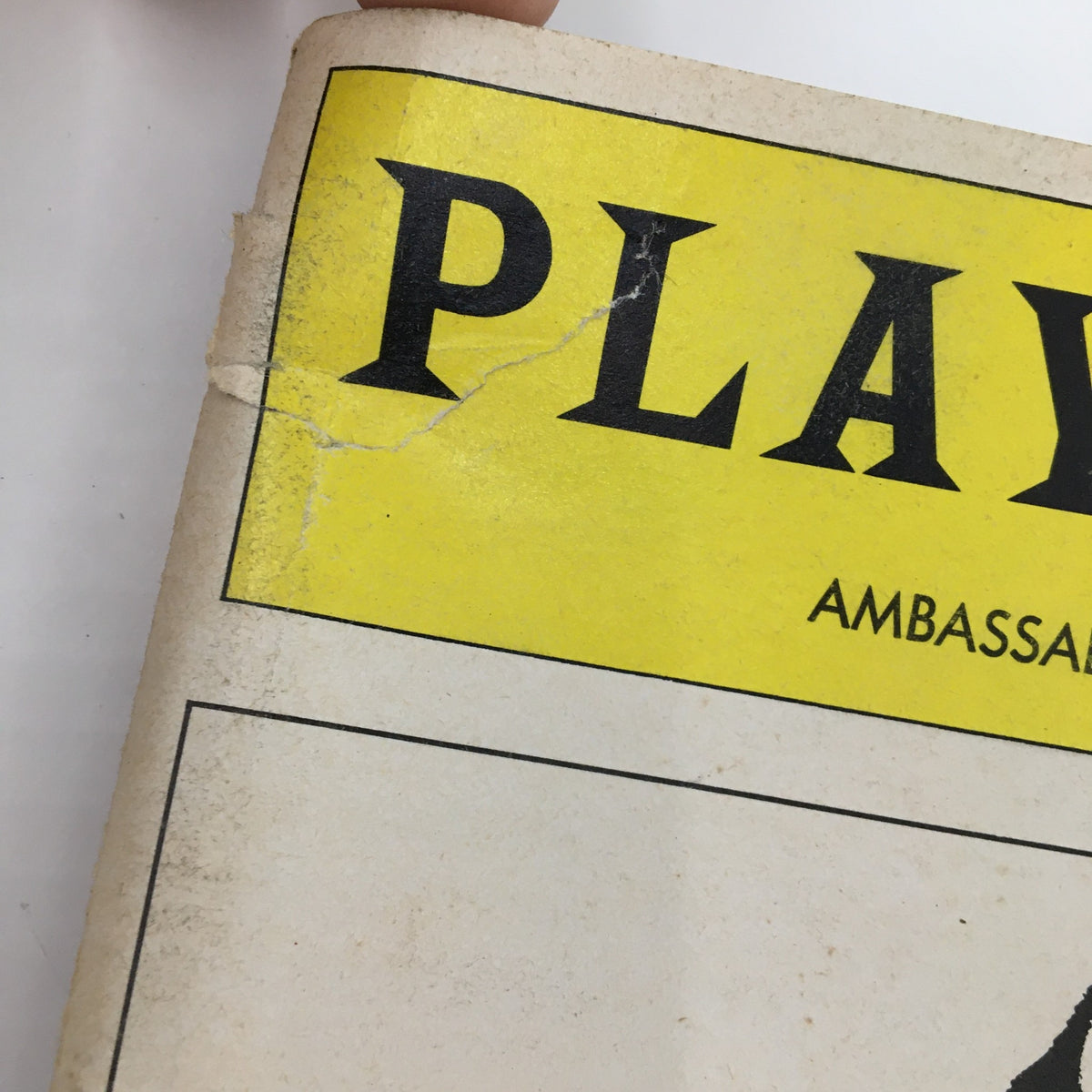 Close-up of the top corner of the 1983 Playbill for A View From The Bridge showing wear and tear at the Ambassador Theatre.