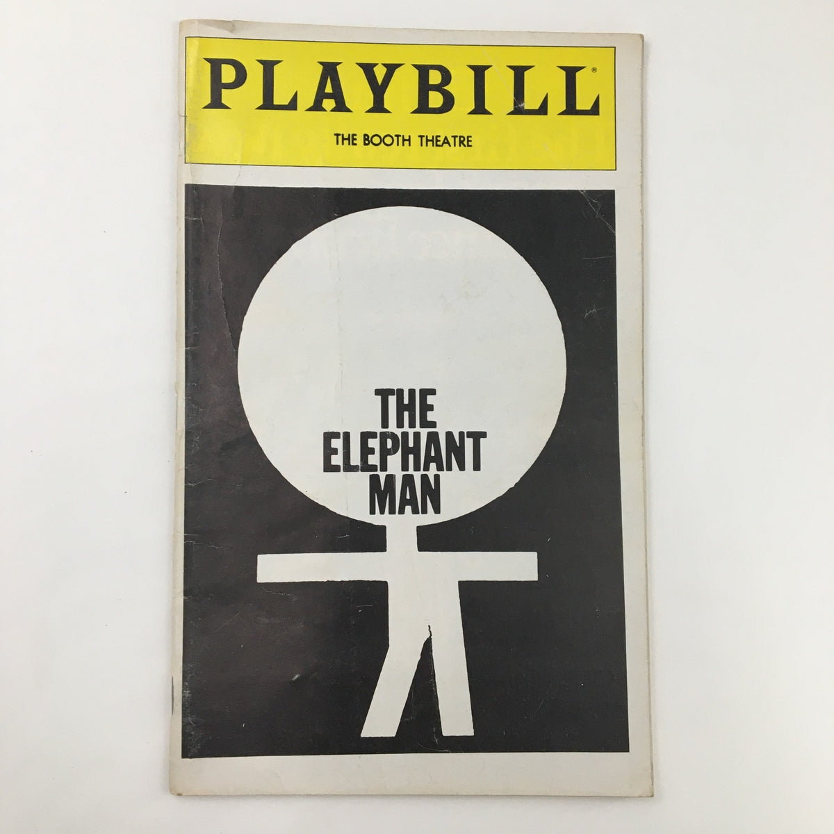 Front cover of the 1981 Playbill for The Elephant Man at The Booth Theatre, featuring a minimalist design with a striking graphic and the title prominently displayed.