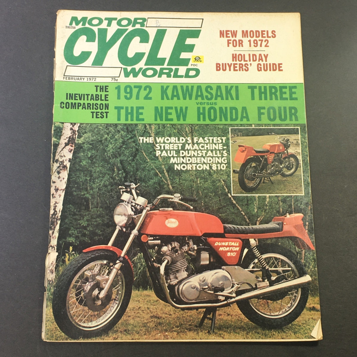 Cover of VTG Motor Cycle World Magazine February 1972 featuring articles on the 1972 Kawasaki Three versus the new Honda Four, showcasing vintage motorcycle culture.