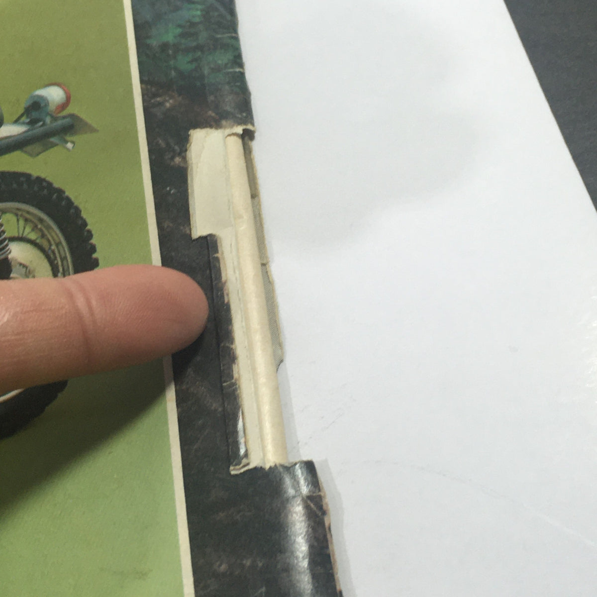 Detail image showing the edge of the VTG Motor Cycle World Magazine February 1972, highlighting minor wear and tear typical of vintage publications.