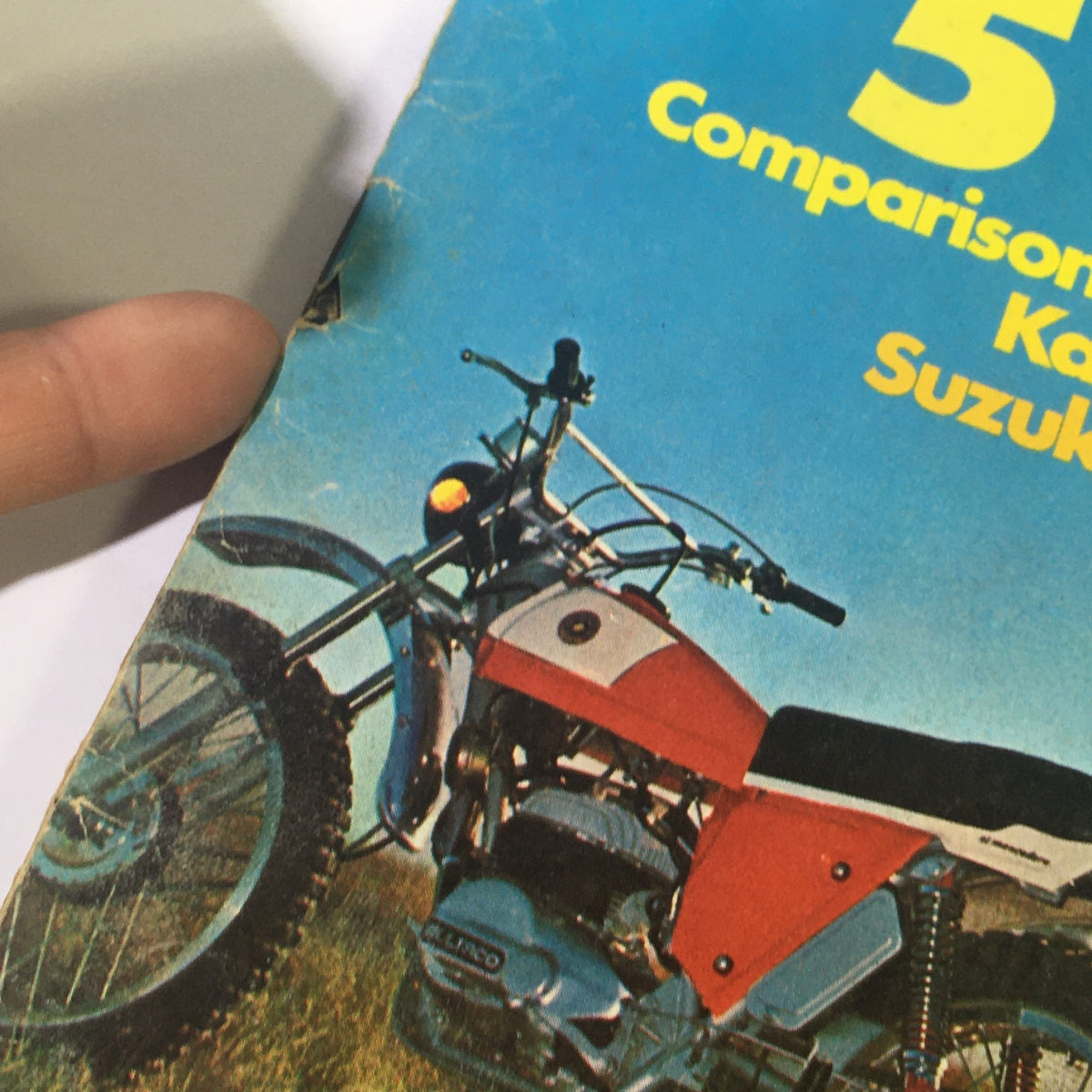 Vintage Cycle World Magazine March 1972 cover featuring a comparison of dirt bikes, including Yamaha and Bultaco models, with a Kawasaki 750. The image highlights the colorful design and iconic motorcycles of the early '70s, reflecting the era's motocross culture.
