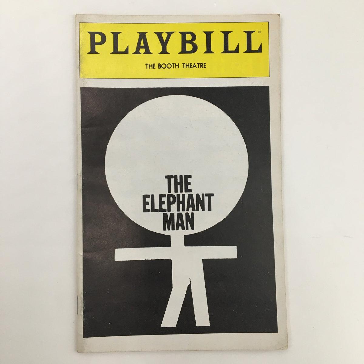 Cover of the 1981 Playbill for The Elephant Man at The Booth Theatre featuring a minimalist design with a large circle and a figure, highlighting the iconic play by Bernard Pomerance.