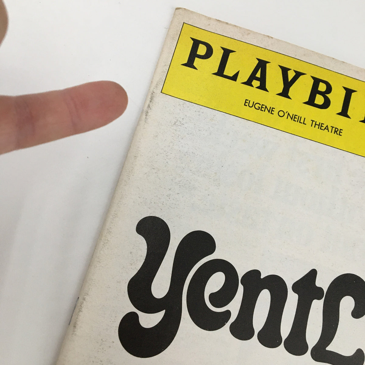 Close-up of the 1975 Playbill for Yentl at Eugene O'Neill Theatre with finger pointing to the yellow header.