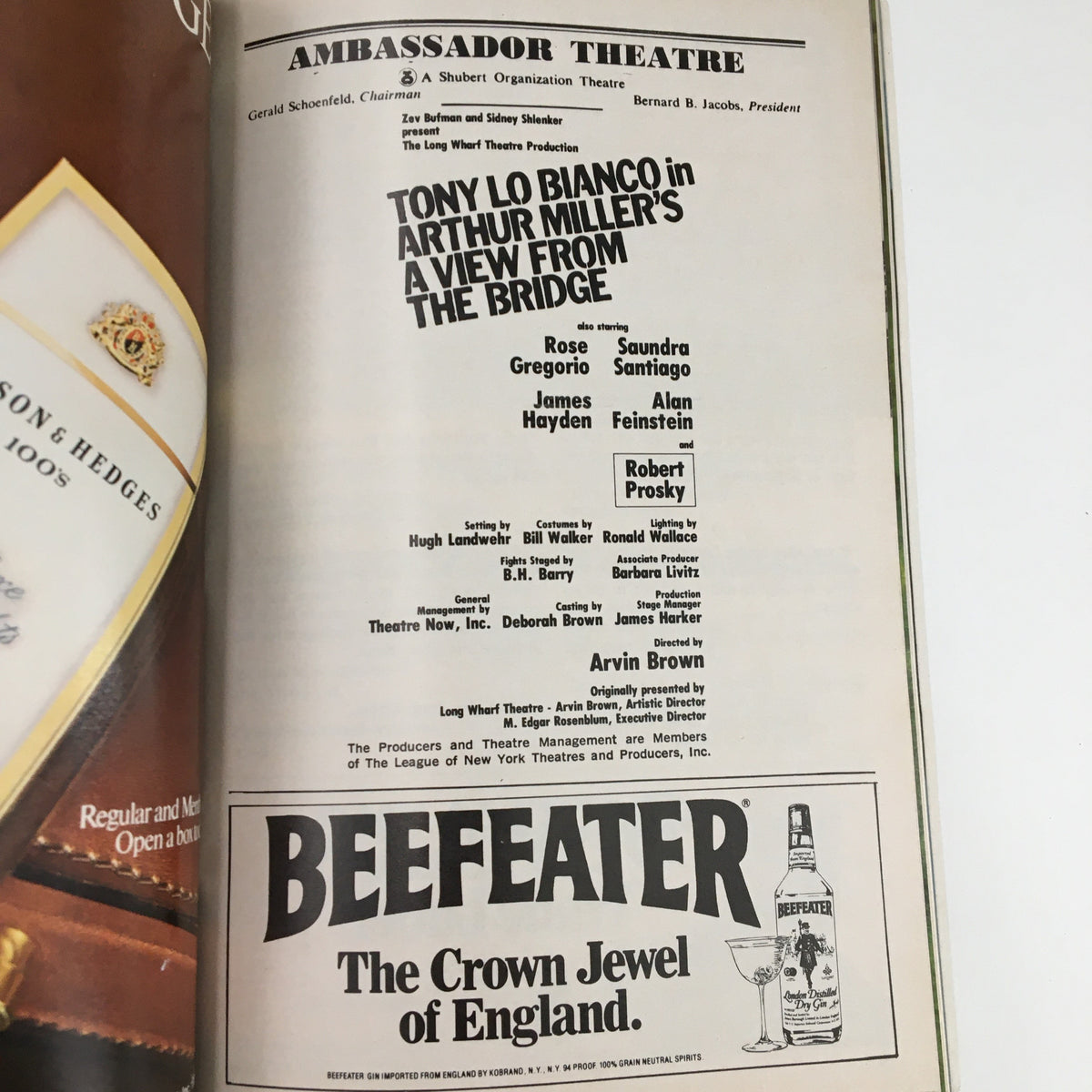 Advertisement page from the 1983 Playbill for Arthur Miller's A View From The Bridge, featuring a cast list and promoting the Ambassador Theatre.