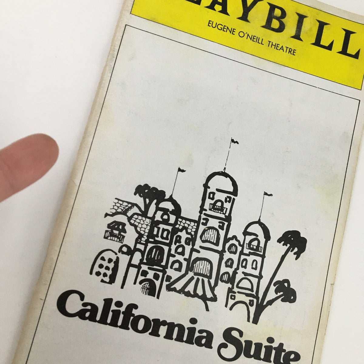 Close-up of the 1976 Playbill California Suites cover, highlighting the artistic illustration and title.