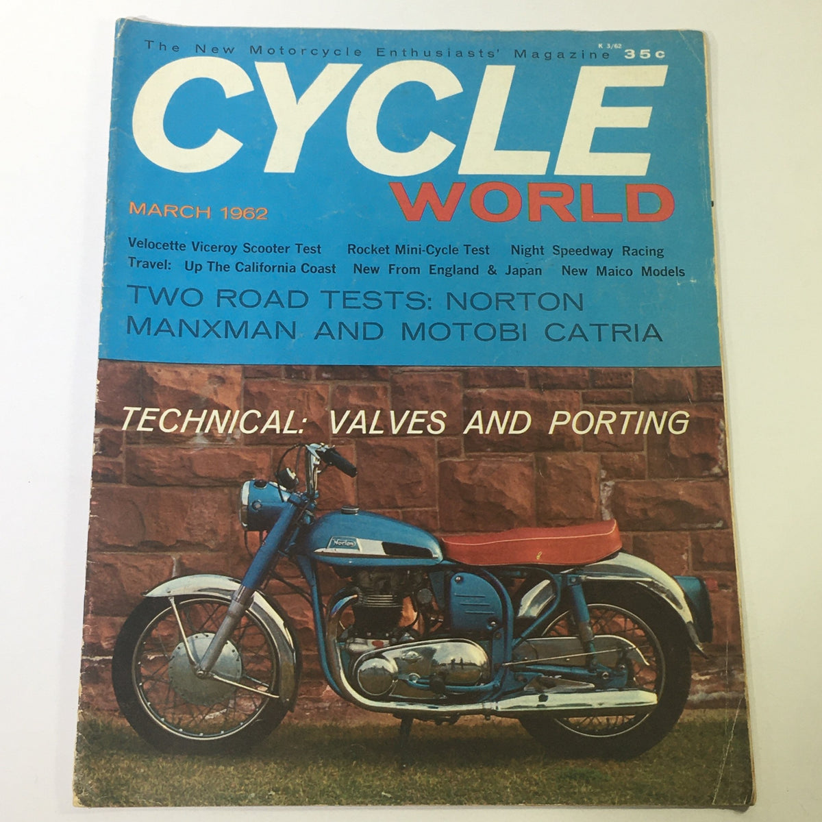 Cover of VTG Cycle World Magazine March 1962 featuring the Norton Manxman and Motobi Catria road tests, showcasing a vintage motorcycle against a stone background.