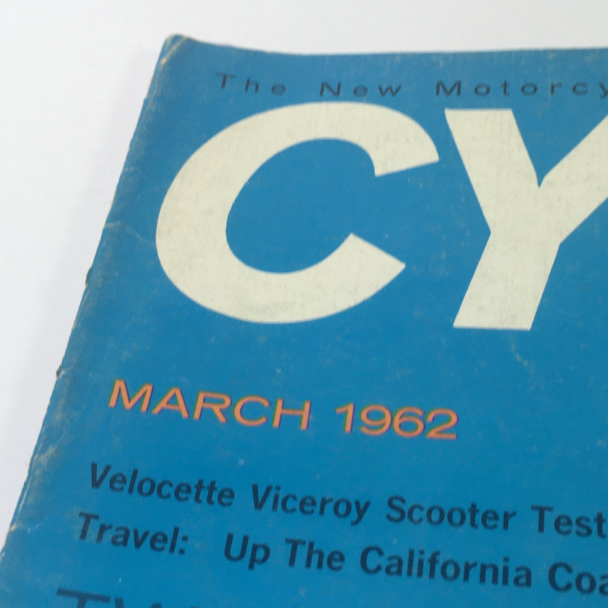 Close-up of the top section of VTG Cycle World Magazine March 1962, featuring the magazine title and date, along with text about scooter tests and travel.
