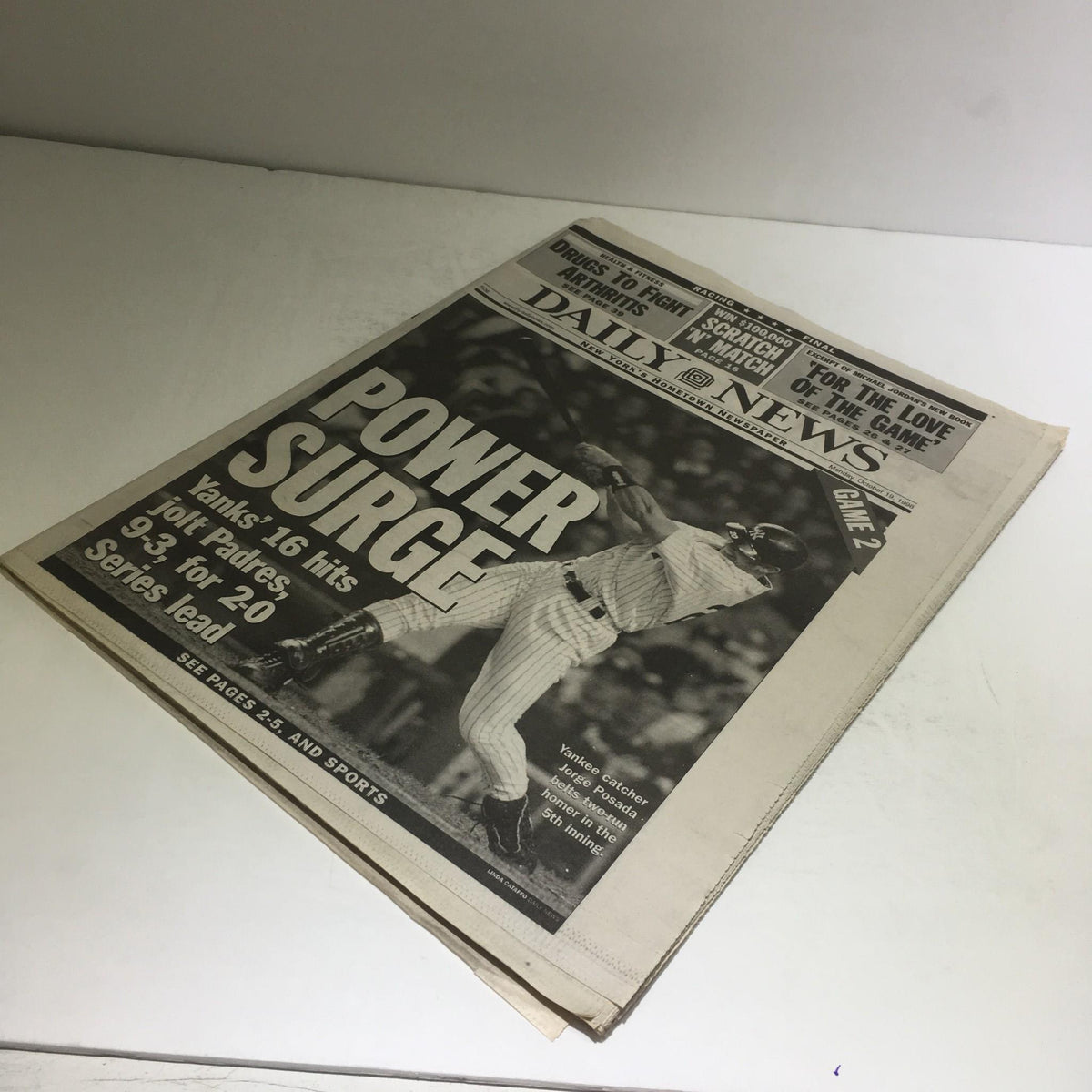 NY Daily News October 19, 1998 cover featuring the headline 'POWER SURGE' detailing Yankees' impressive 16-hit performance against the Padres in World Series, showcasing significant baseball action.