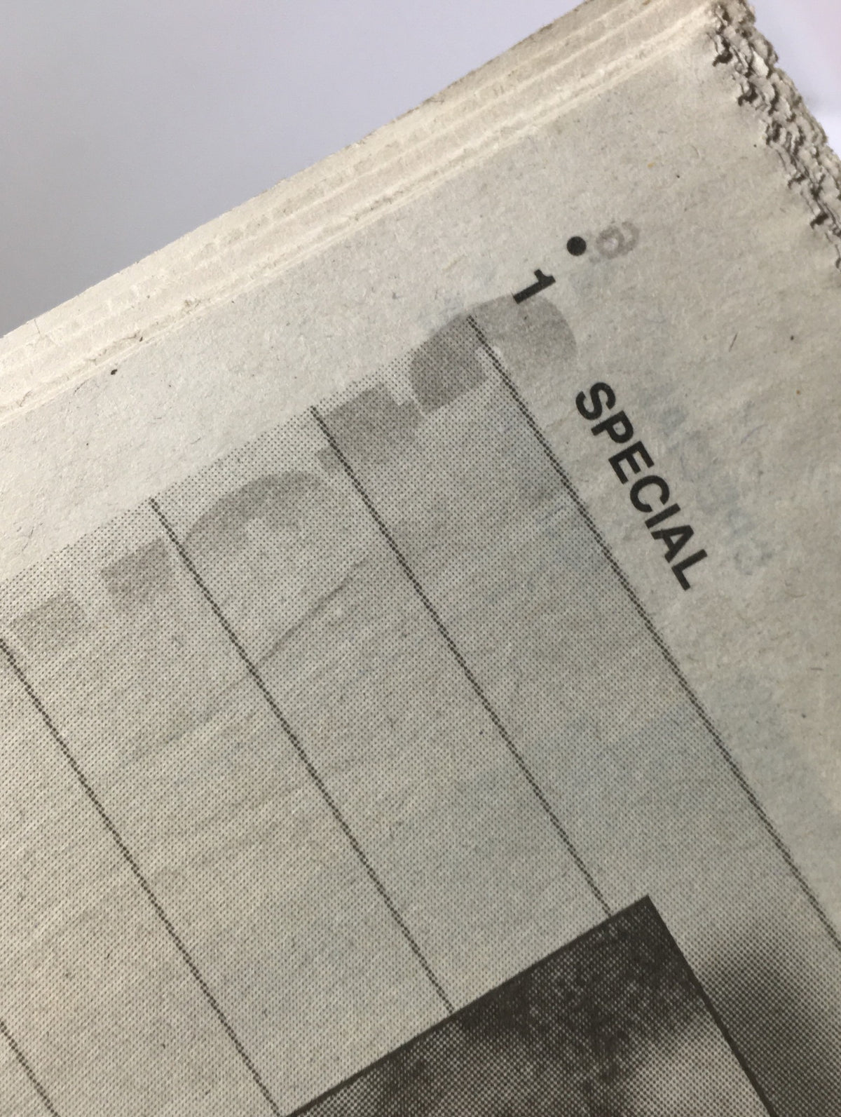 Close-up of the inside edge of a vintage magazine page from the NY Daily News: 10/25/98 Perfect Game, Series Sweep, 125-Win Season, highlighting the word 'SPECIAL' in black text.
