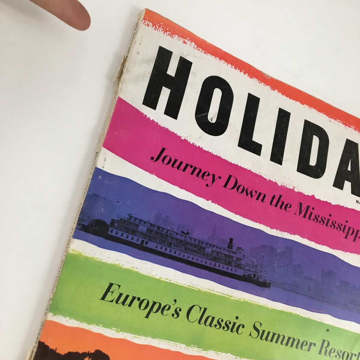 Close-up of the cover of Holiday Magazine May 1963, showing the title 'HOLIDAY' and segments highlighting travel topics.