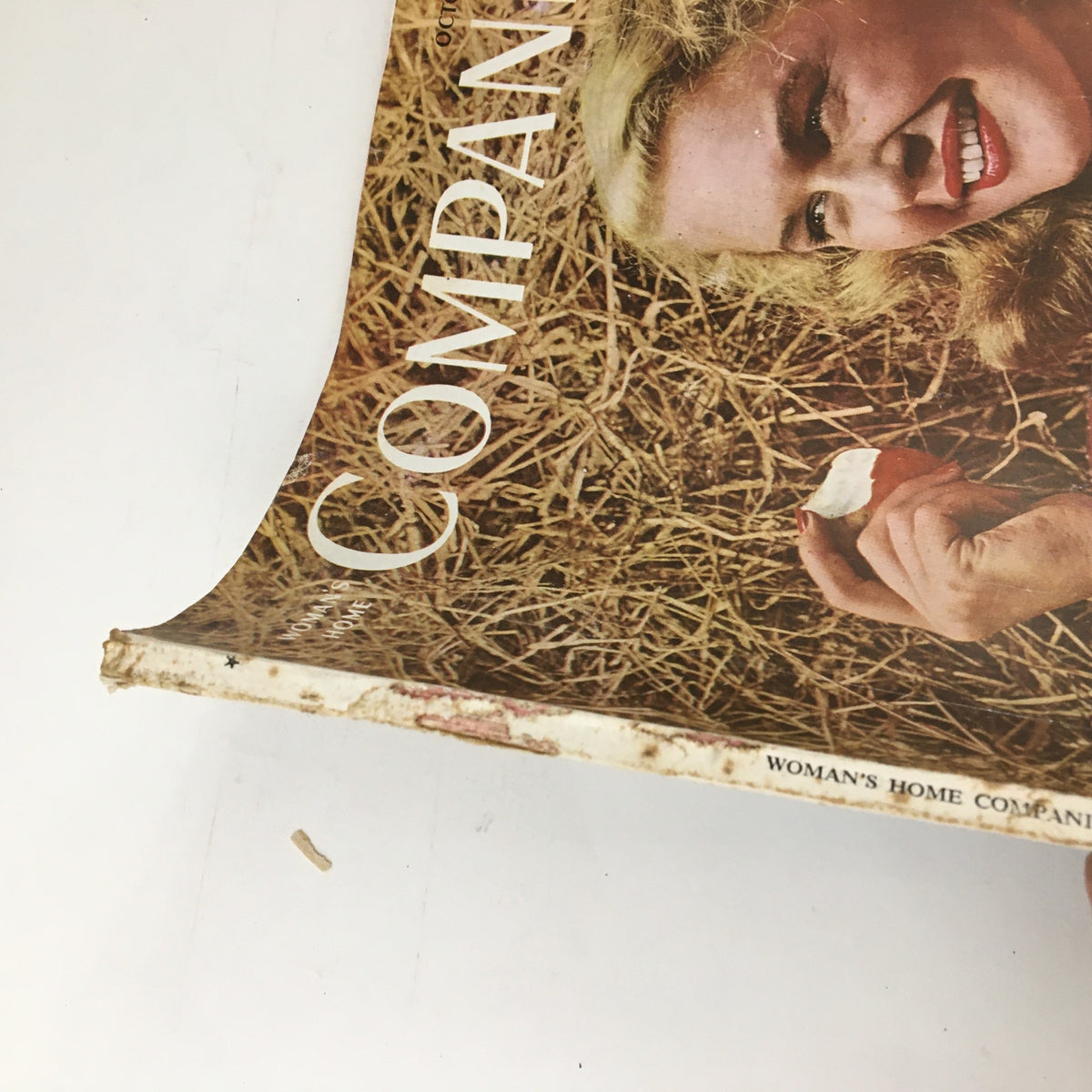 Side view of the Woman's Home Companion October 1946 magazine, highlighting the wear and tear of the cover and the title My Life Behind The Iron Curtain.