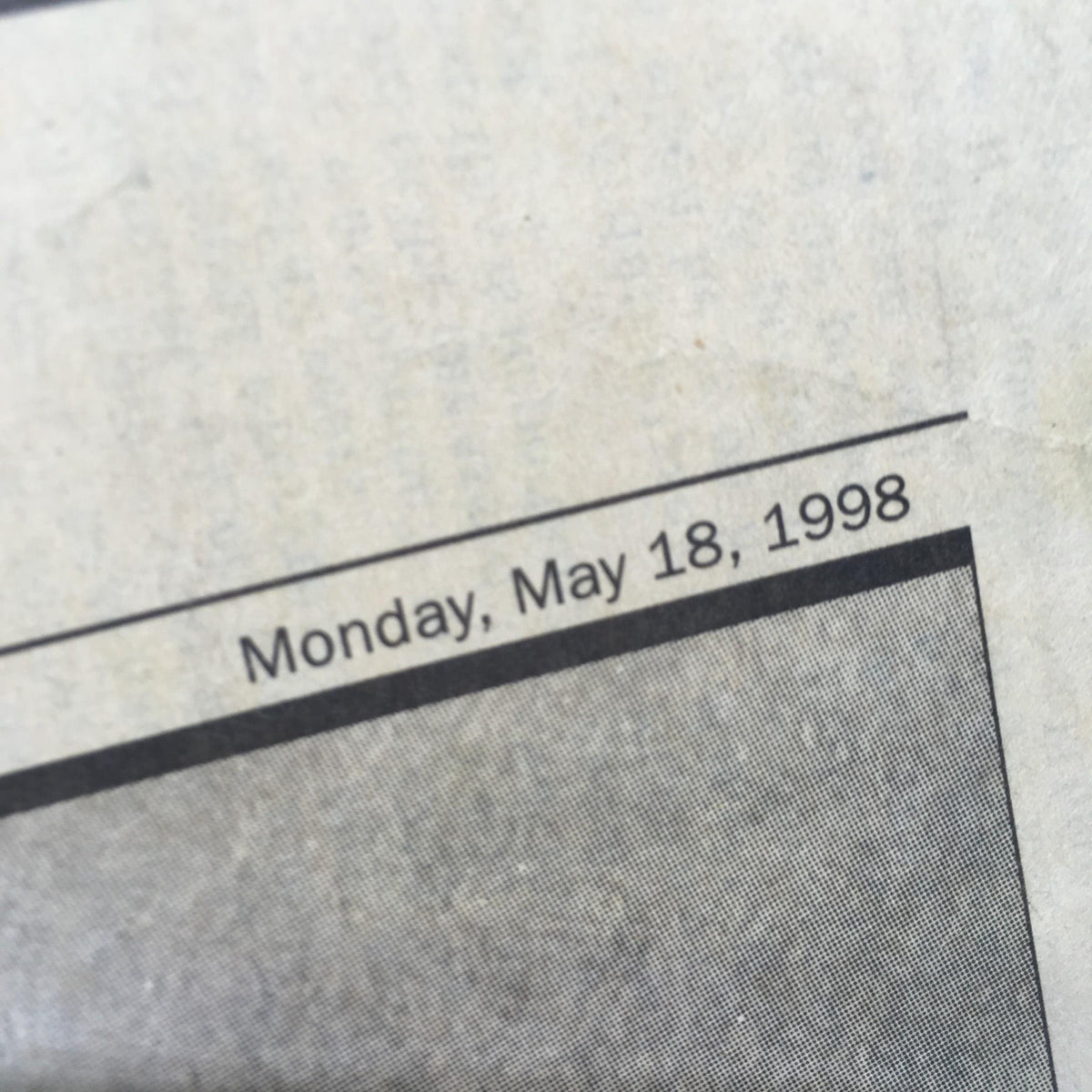 Close-up of the date on the NY Daily News article, stating 'Monday, May 18, 1998', significant for Yankees pitcher David Wells' perfect game.
