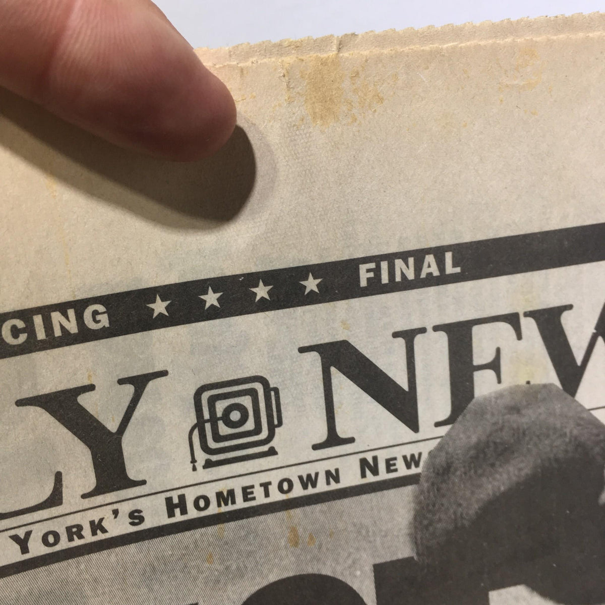 Close-up of the NY Daily News headline from May 18, 1998, featuring a perfect game by Yankees pitcher David Wells, showing mild staining at the top.