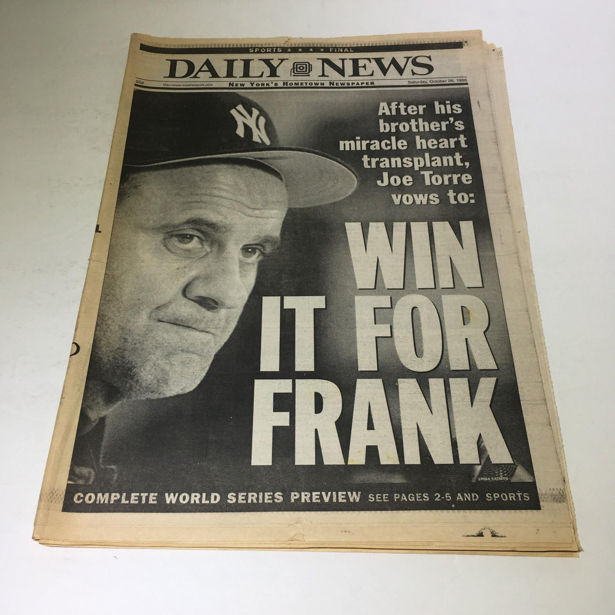 New York Daily News front page from October 26, 1996, featuring the headline 'Win It For Frank' with a close-up of Joe Torre, emphasizing his vow after his brother's heart transplant.
