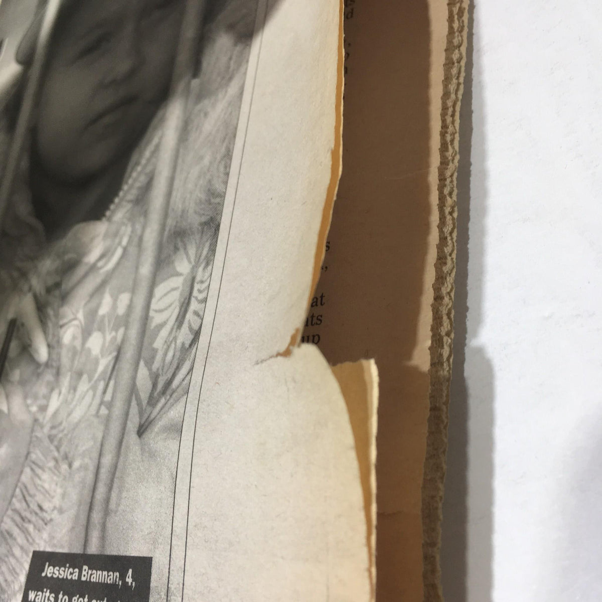 Side angle of a worn edge on the New York Daily News newspaper from October 27, 1996, showcasing a tear and showing the newspaper's aged condition, related to the 'Goin' For Glory' issue.