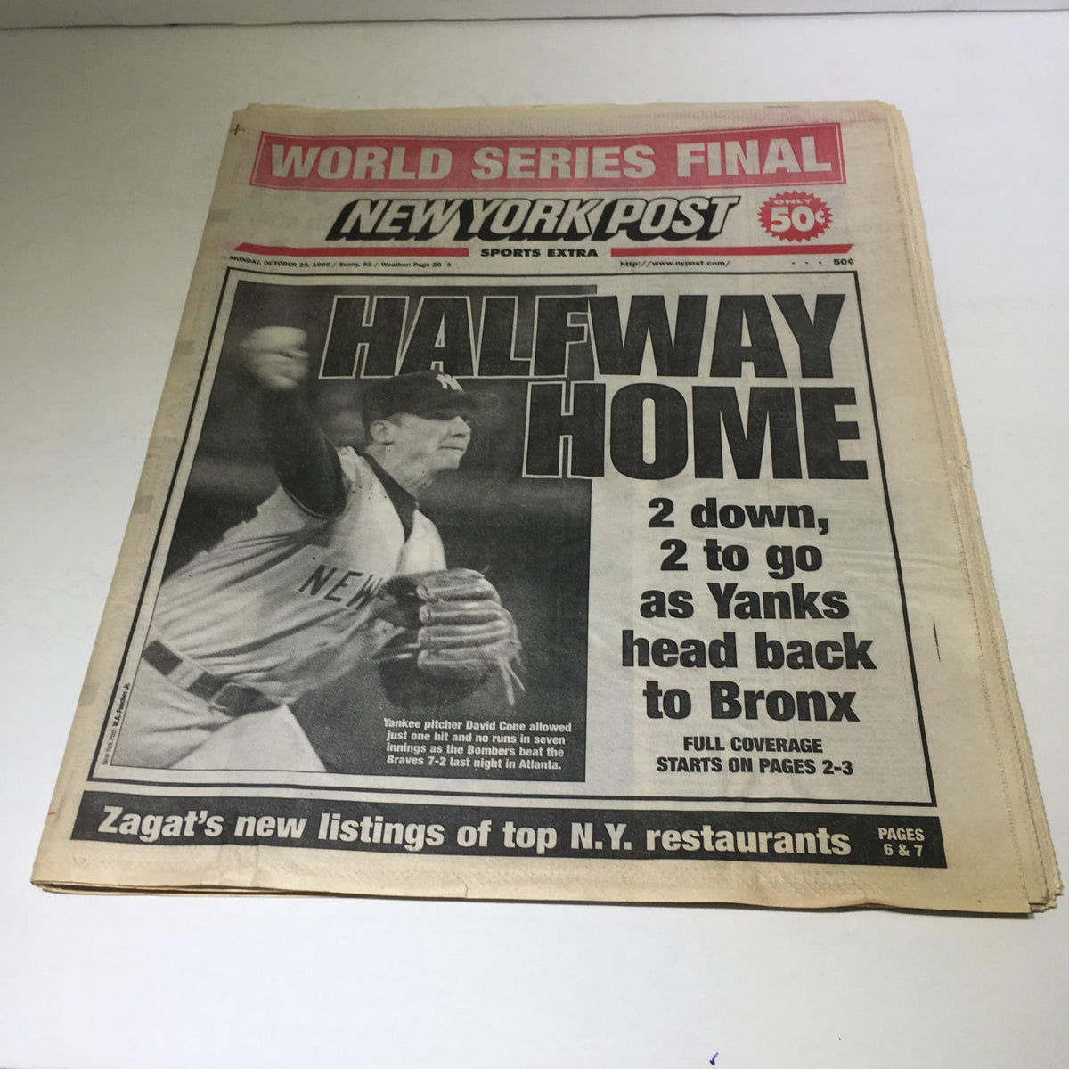 NY Post newspaper dated October 25, 1999, featuring the title 'Halfway Home 2 Down 2 To Go As Yanks Head Back To Bronx'. The cover displays an image of a New York Yankees pitcher alongside World Series details.