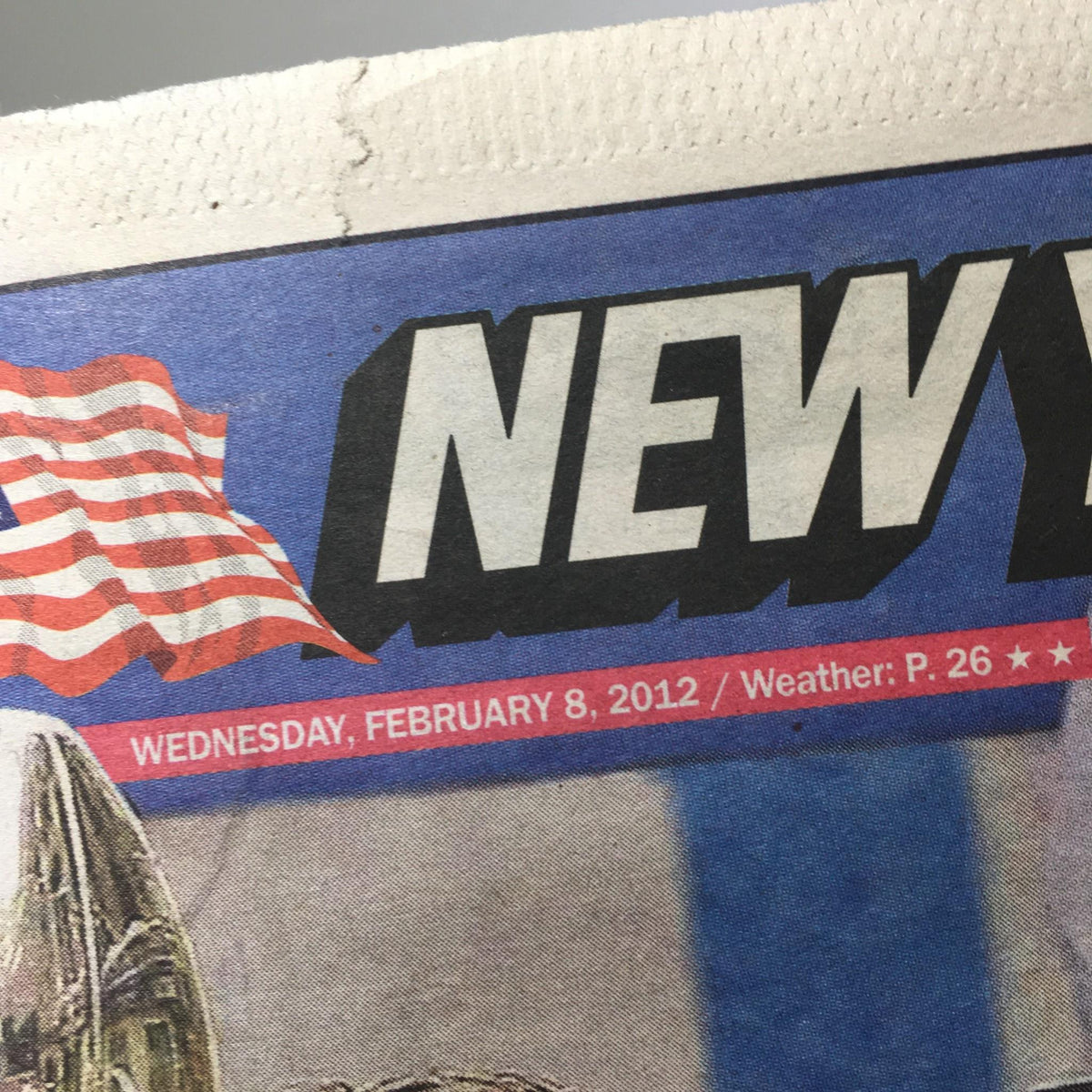 Close-up of the New York Post headline from February 8, 2012, featuring 'New York Post' and the date prominently displayed.