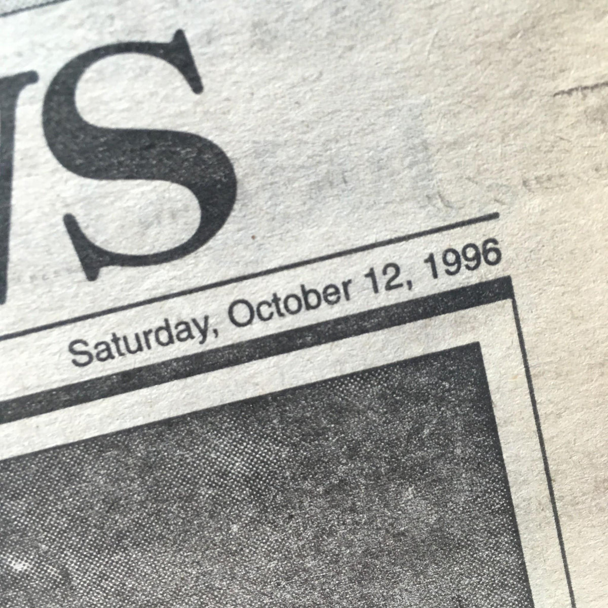 Close-up of the date on the New York Daily News from October 12, 1996, showcasing the publication date details.