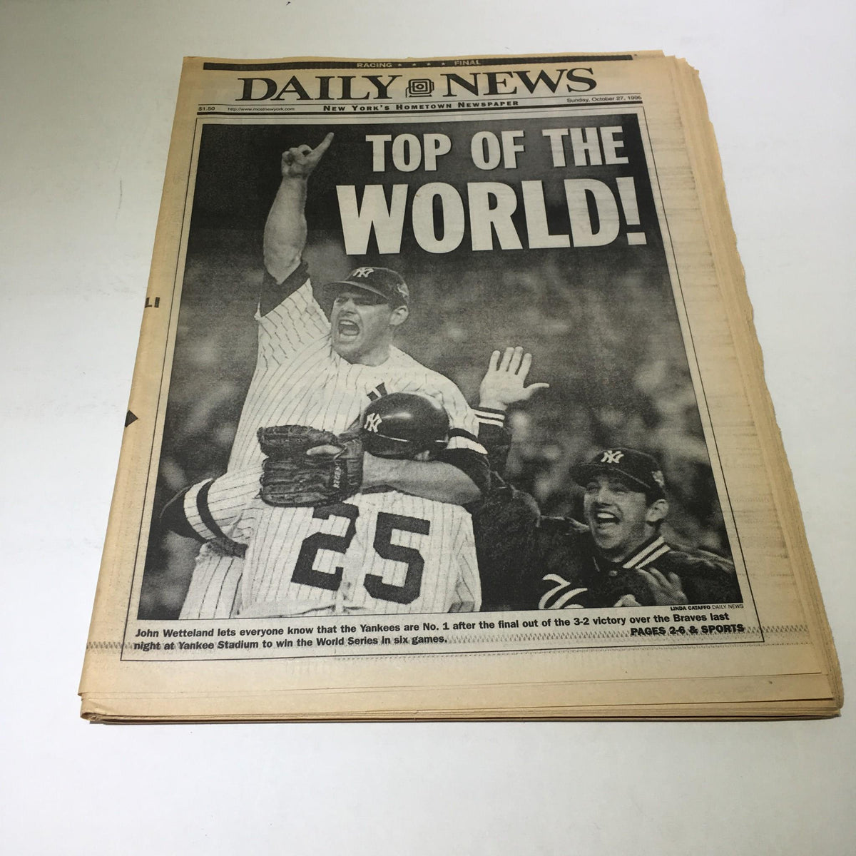 New York Daily News: Oct 27, 1996 cover showing jubilant Yankees players celebrating with the headline 'TOP OF THE WORLD!' after winning the World Series.