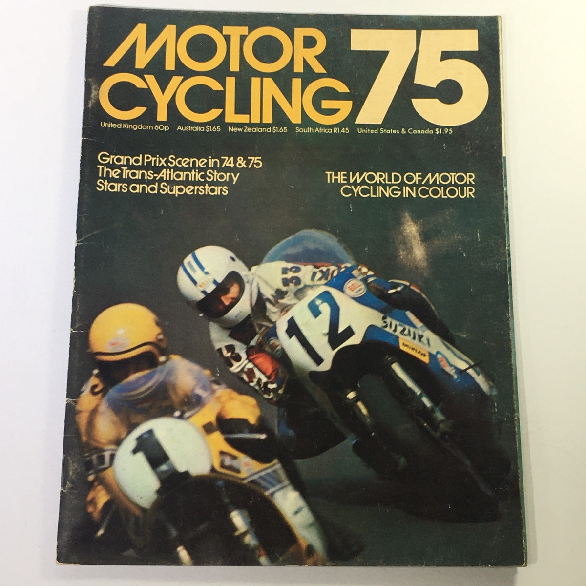 Cover of the Vintage Motor Cycling Magazine 1975 showcasing the Grand Prix Scene and Trans-Atlantic Story, featuring a dramatic motorcycle race with riders in vibrant gear.