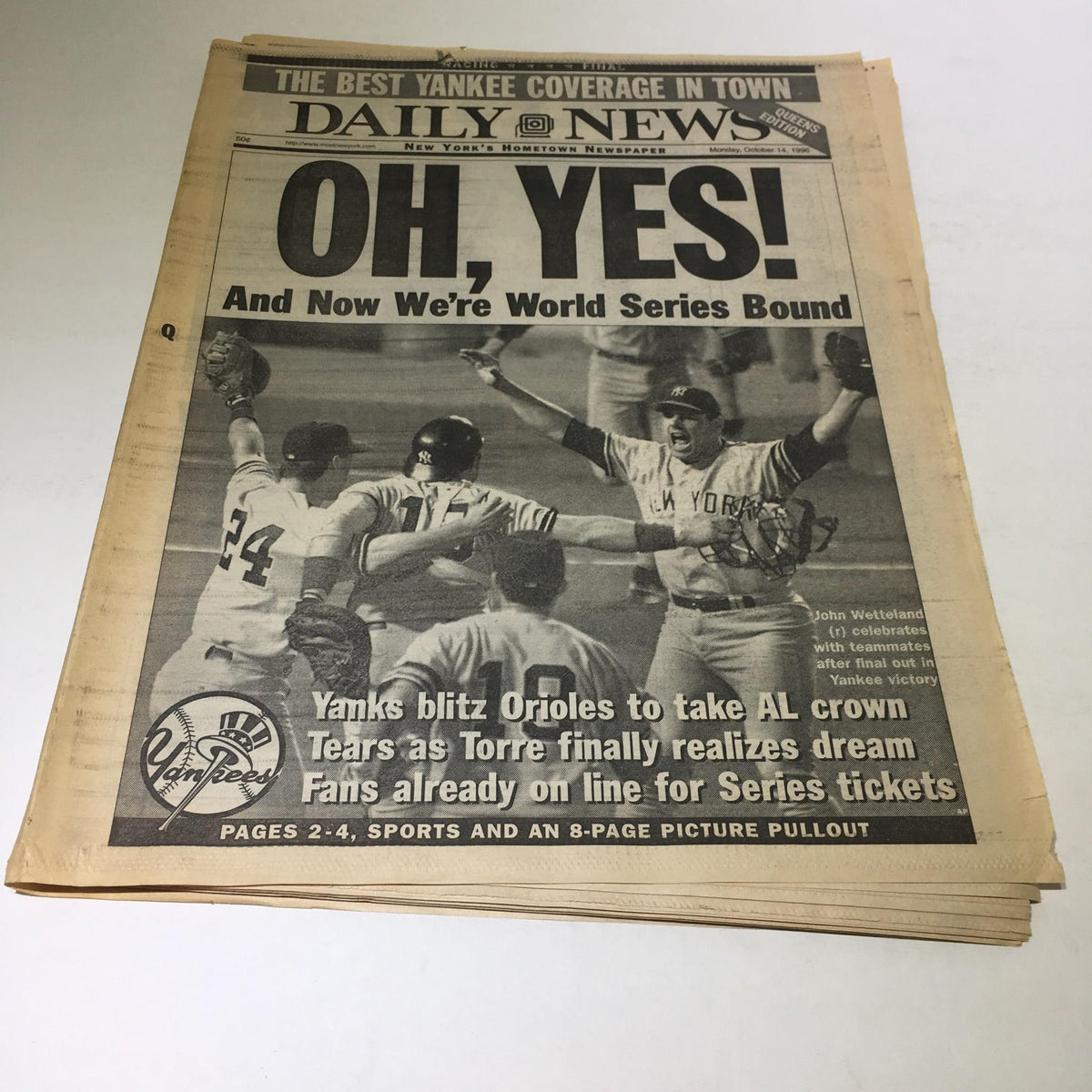 NY Daily News front page from October 14, 1996, featuring John Wetteland celebrating with teammates after a New York Yankees victory, highlighting the World Series bound announcement.