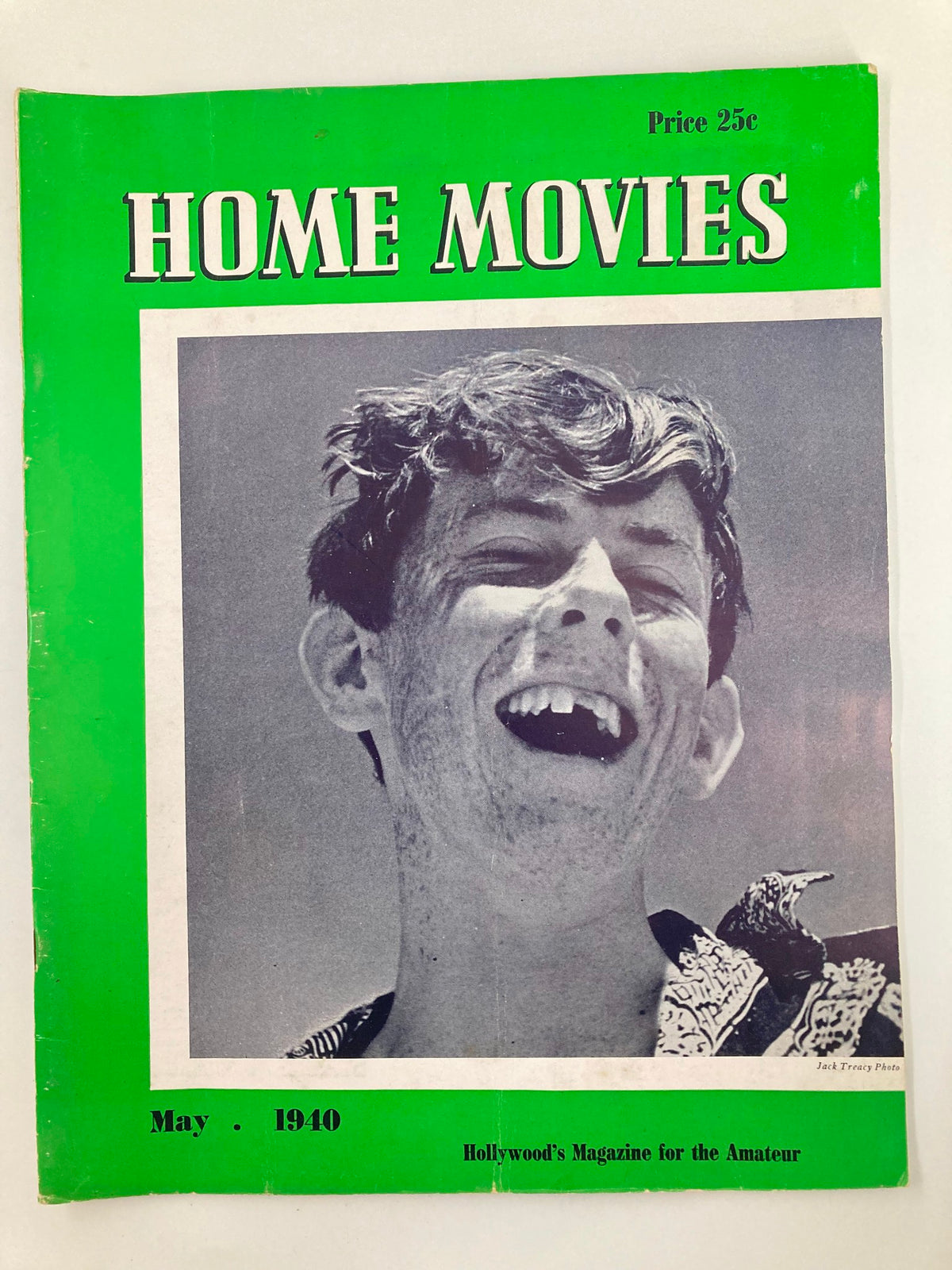 Cover of VTG Home Movies Magazine from May 1940 featuring a smiling young boy, photo by Jack Treacy, showcasing the vintage publication's unique green design and nostalgic appeal.