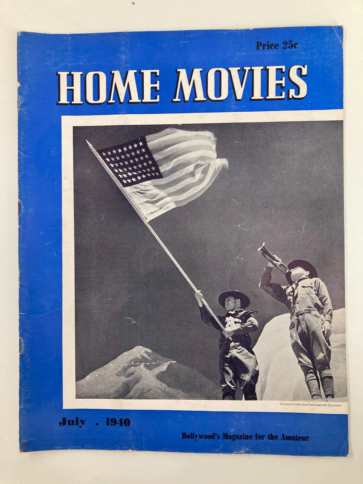 VTG Home Movies Magazine July 1940 cover featuring two cowboys, one holding an American flag and the other playing a trumpet, showcasing Hollywood's Magazine for the Amateur.