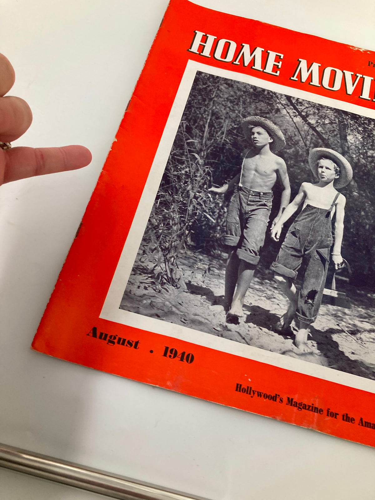 Close-up of the Vintage Home Movies Magazine cover from August 1940, illustrating two boys in straw hats, with emphasis on the magazine's title and minor wear details.