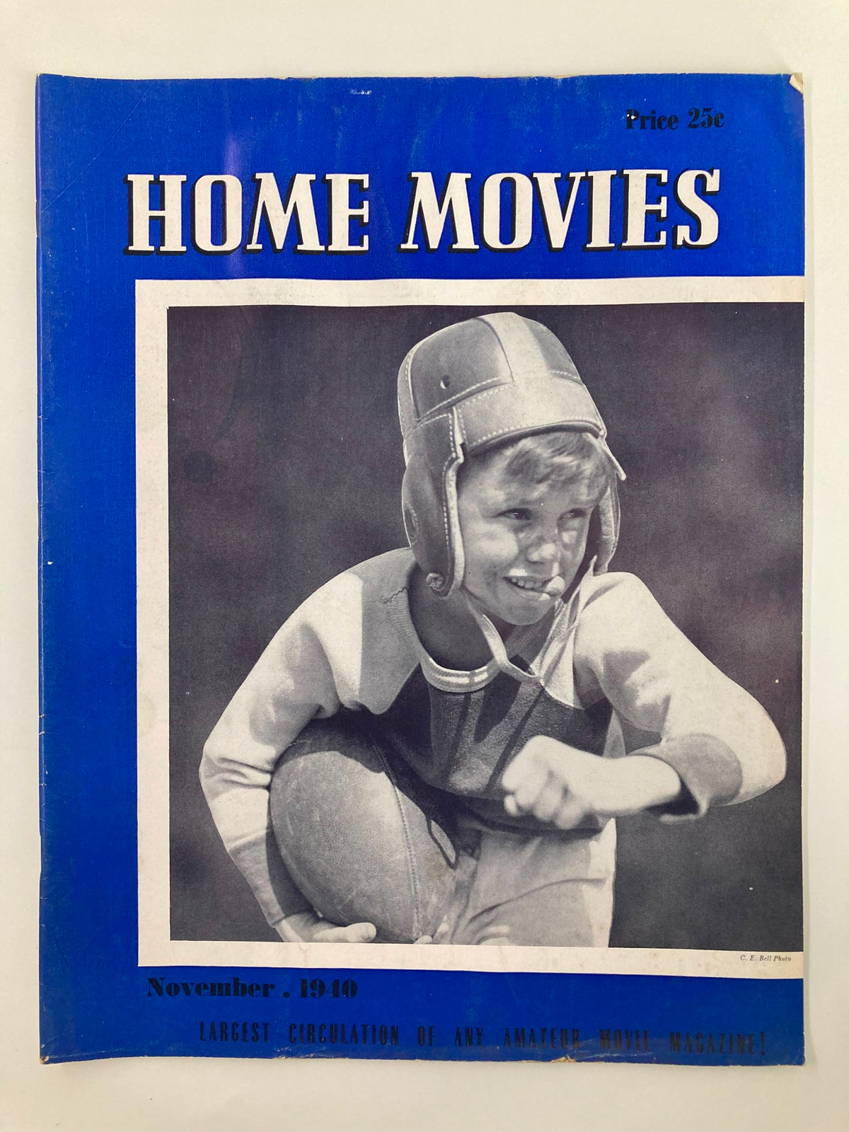 Front cover of VTG Home Movies Magazine November 1940 featuring a boy in a safety helmet holding a football. The magazine is titled 'Home Movies' with details about the issue.