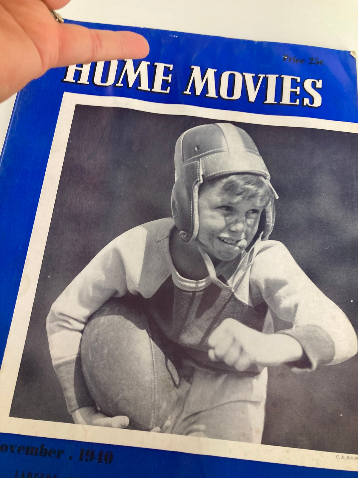 Close-up view of the front cover of VTG Home Movies Magazine November 1940, showcasing a young boy in protective gear and the magazine title 'Home Movies' prominently displayed.