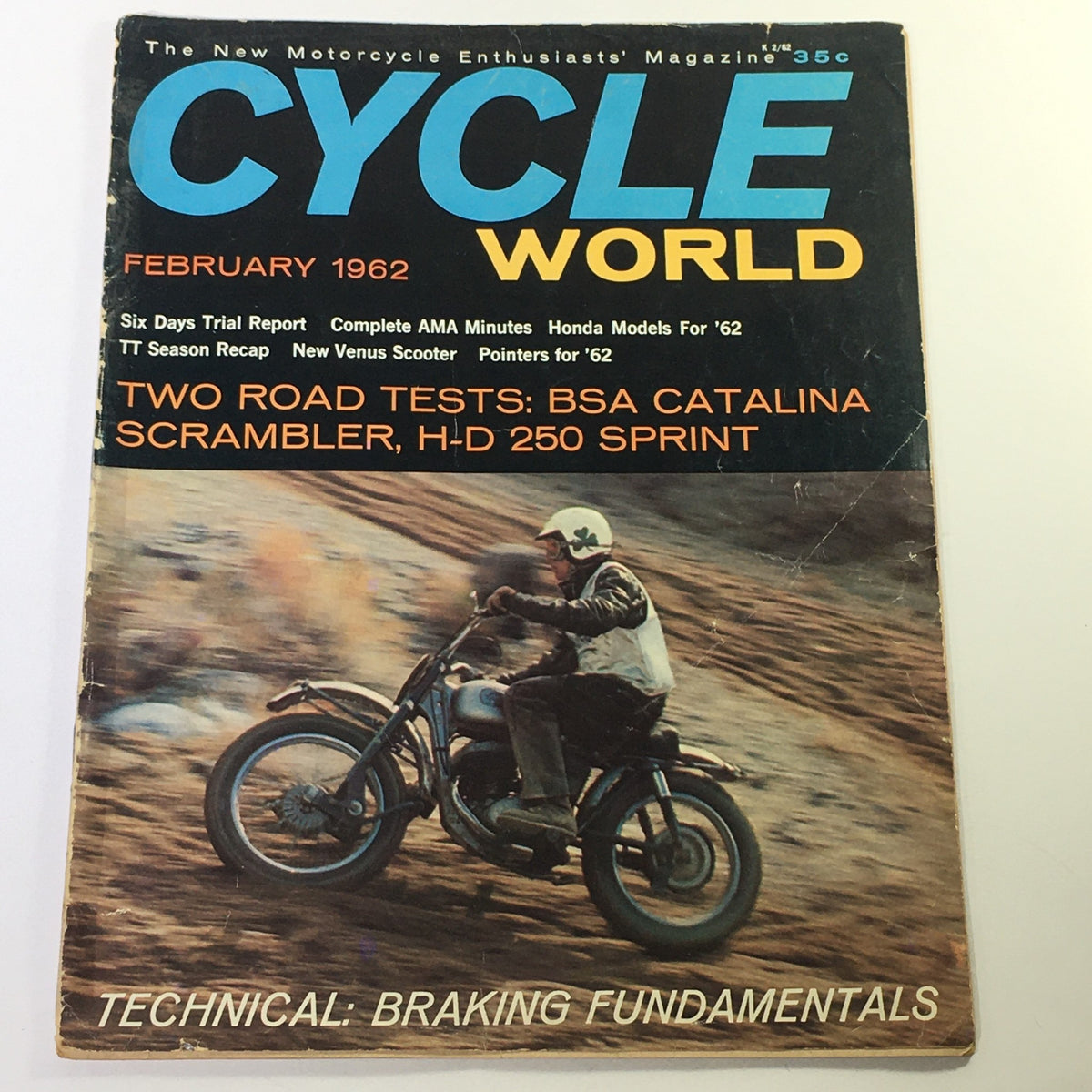 Cover of the VTG Cycle World Magazine, February 1962, showcasing BSA Catalina Scrambler and H-D 250 Sprint. Features a rider on a motorcycle against a rugged landscape, highlighting motorcycle innovation of the early 1960s.