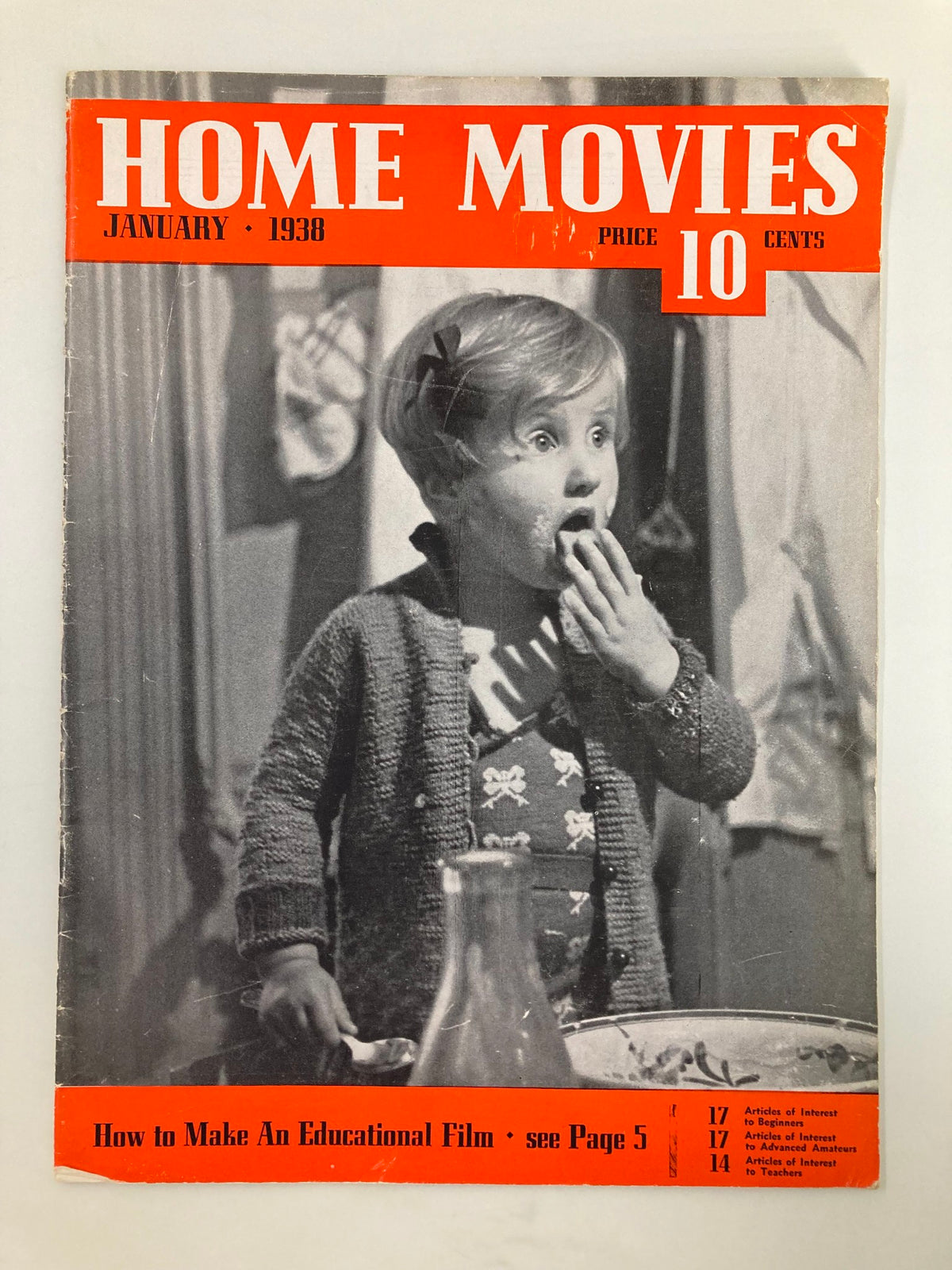 VTG Home Movies Magazine January 1938 cover featuring a child with a surprised expression, highlighting topics such as home filmmaking and educational film techniques.