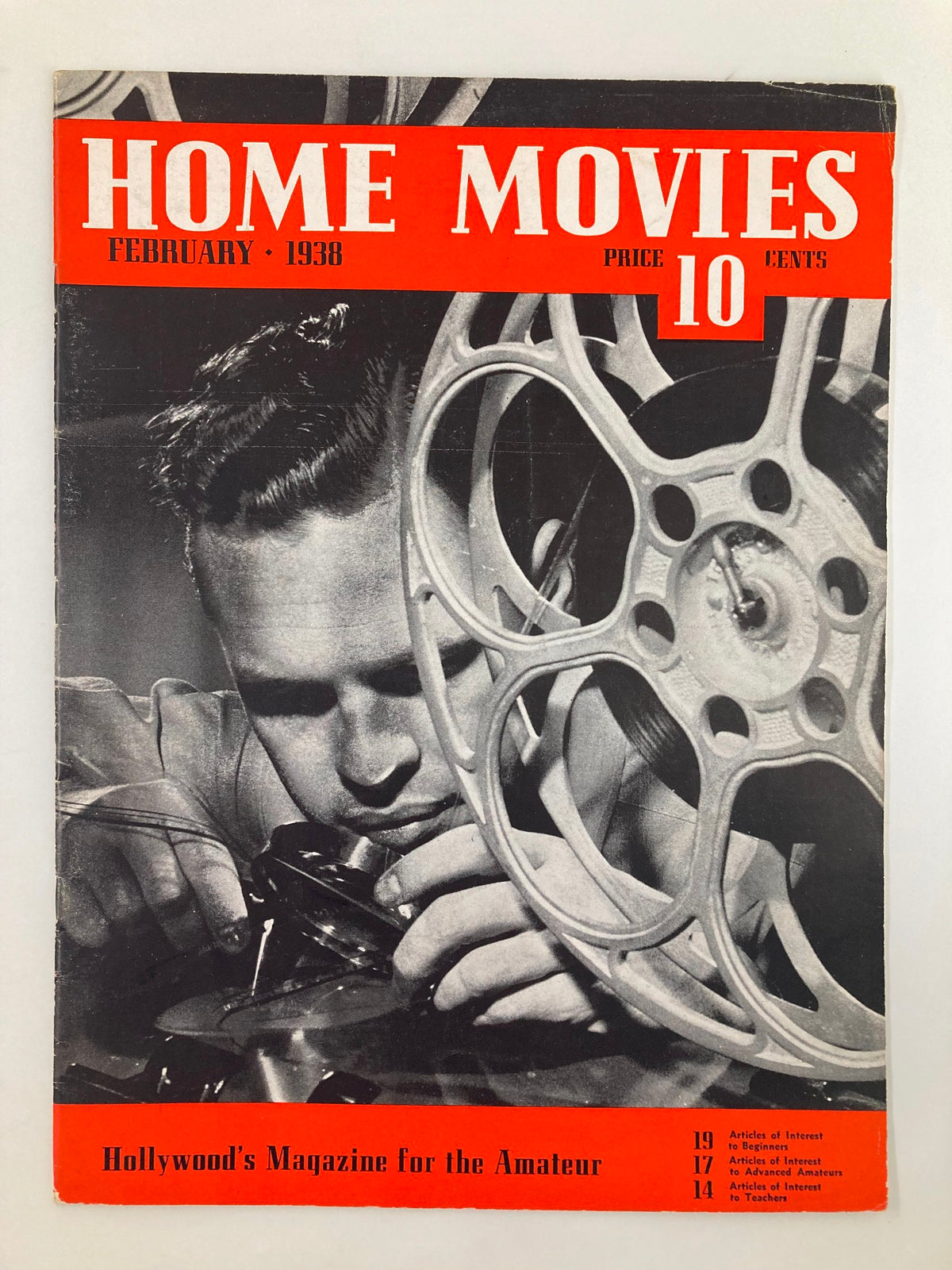 Cover of VTG Home Movies Magazine February 1938 featuring a young man working with film equipment, showcasing the magazine's focus on amateur filmmaking.