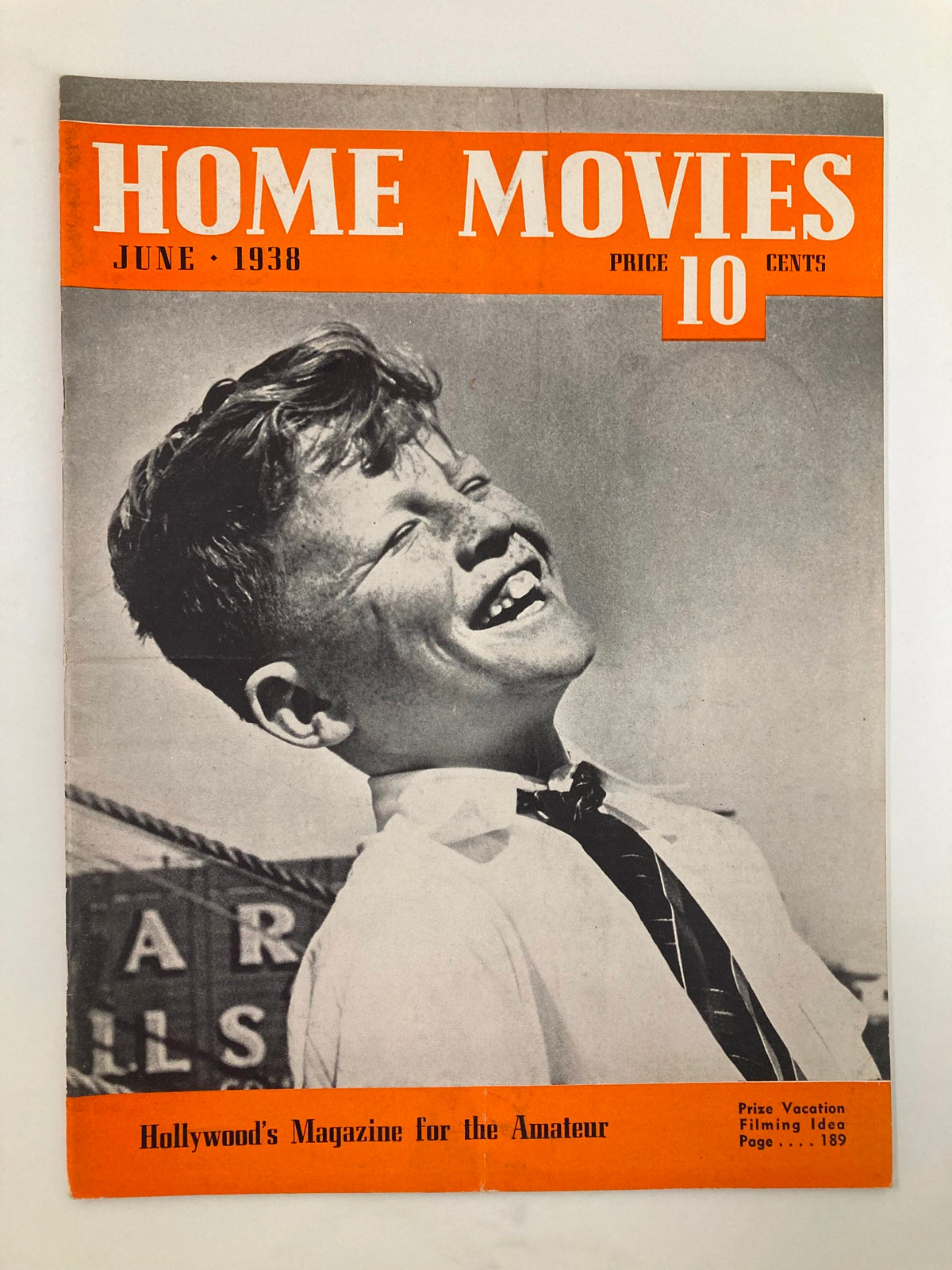 VTG Home Movies Magazine June 1938 cover featuring a smiling boy, showcasing vintage design elements and the tagline 'Hollywood's Magazine for the Amateur'.