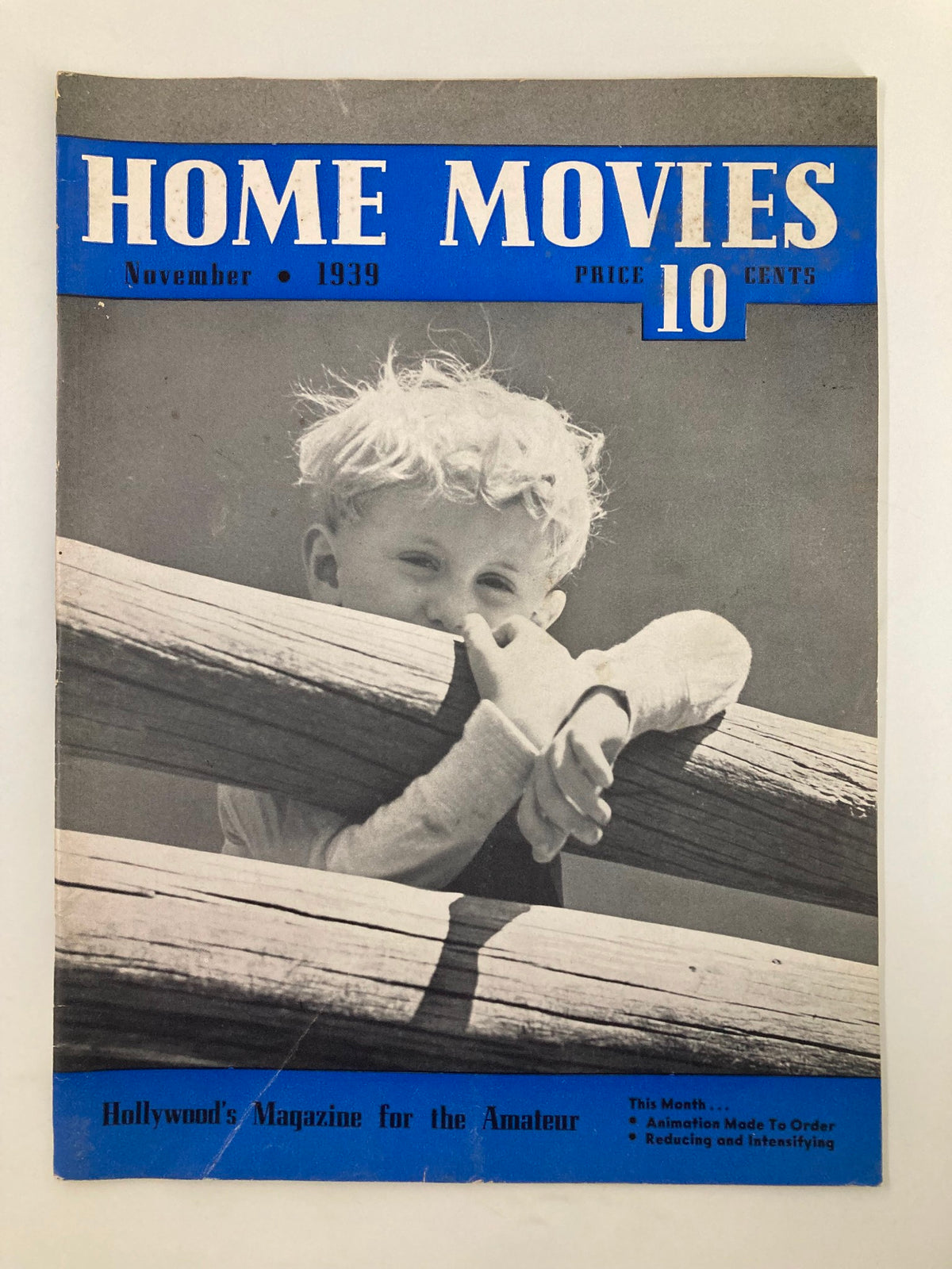 Cover of VTG Home Movies Magazine November 1939 featuring a child peeking over a wooden fence, showcasing the magazine's title and price.