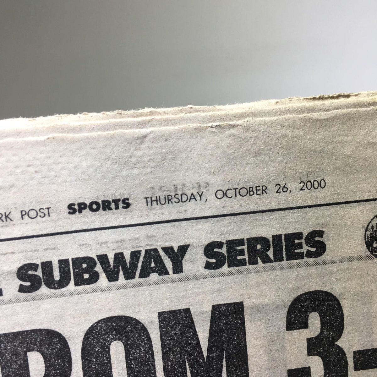 Close-up of the NY Daily News date section, showcasing 'Thursday, October 26, 2000' along with the title 'Subway Series' and the headline 'Stop From 3-Peat'.