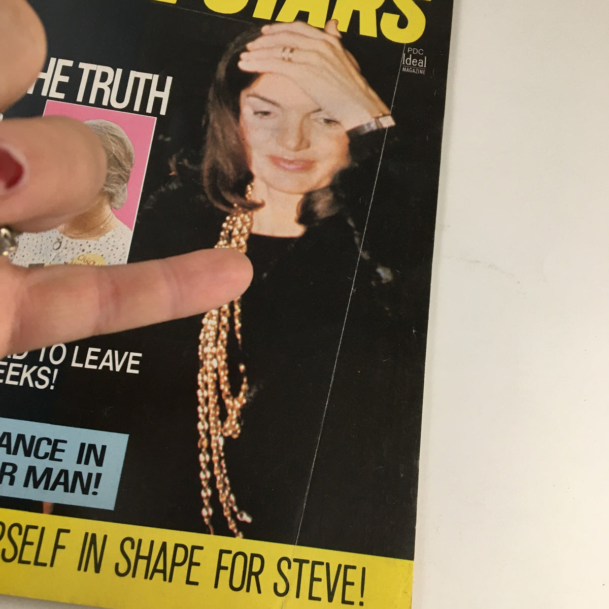 Close-up view of the cover of Movie Stars Magazine June 1973 showcasing Jackie Onassis and stories about TV celebrities.