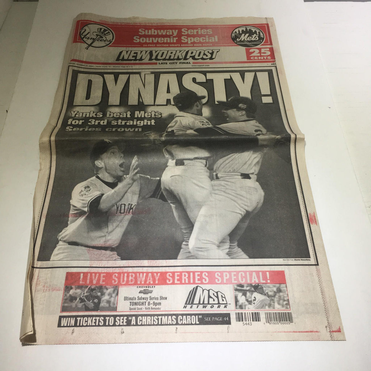 Vintage newspaper cover featuring the New York Post headline 'Dynasty! Yanks Beat Mets For 3rd Straight Series Down' celebrating the Yankees' World Series victory, with images of jubilant players.