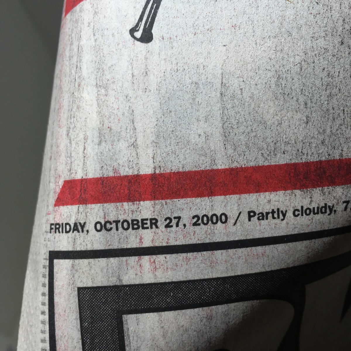Close-up of the date on the vintage New York Post newspaper, dated Friday, October 27, 2000, highlighting a special baseball event.