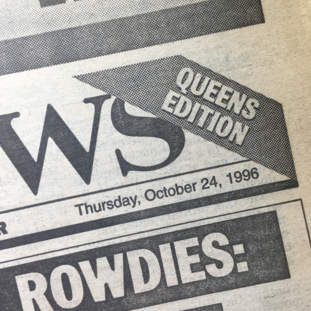 Close-up detail of the New York Daily News from October 24, 1996, showing the date and the tag 'Queens Edition' prominently on the paper.