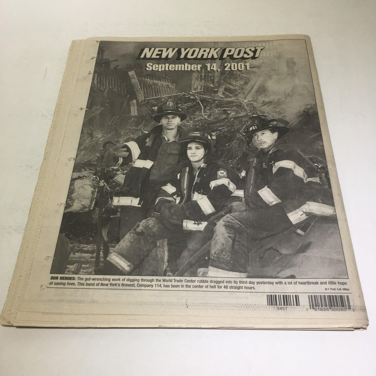 Cover of the New York Post from September 14, 2001, featuring firefighters at Ground Zero, capturing the profound impact of the 9/11 tragedy.