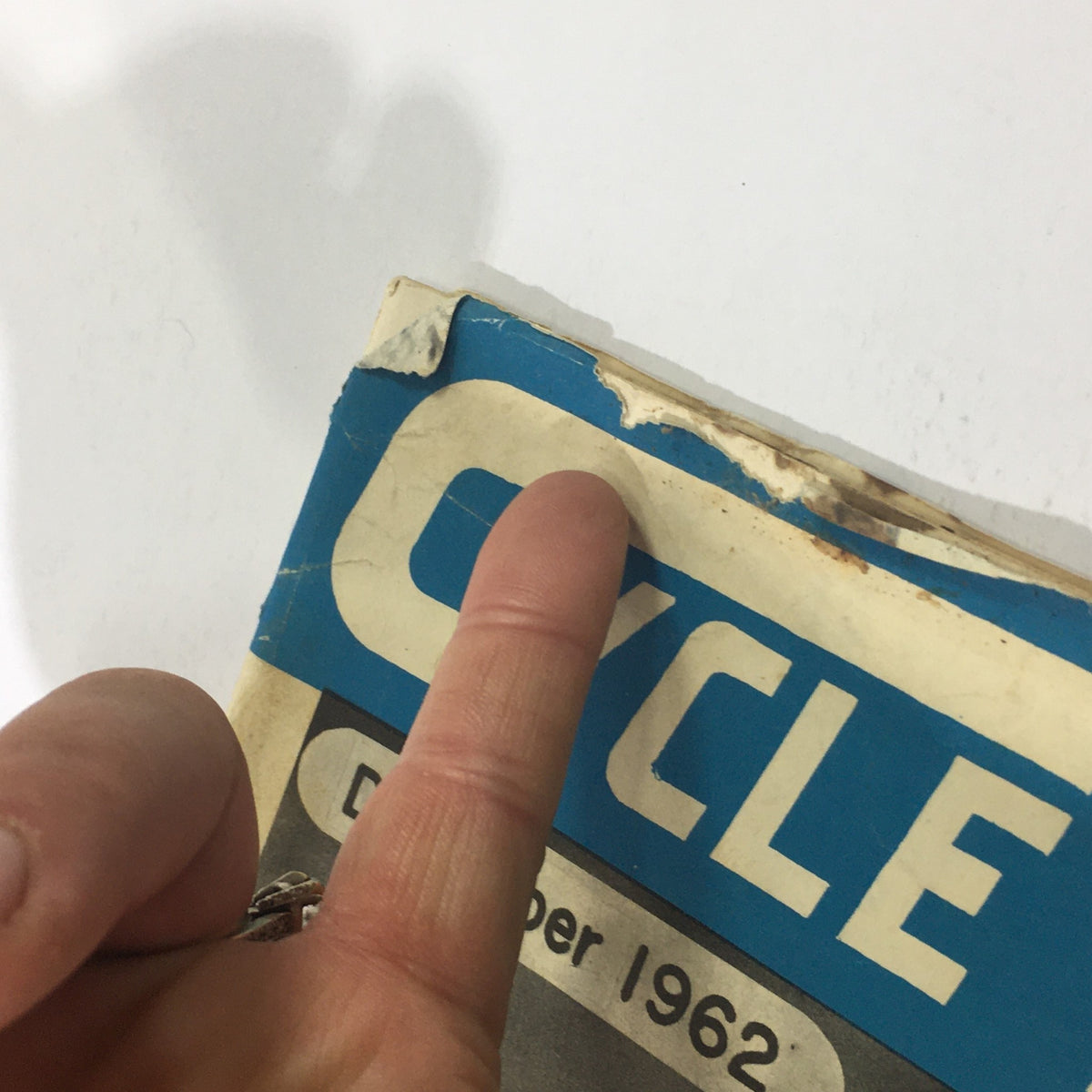 Detailed view of the edge of the VTG Cycle Sport Magazine December 1962, highlighting its age with noticeable wear.
