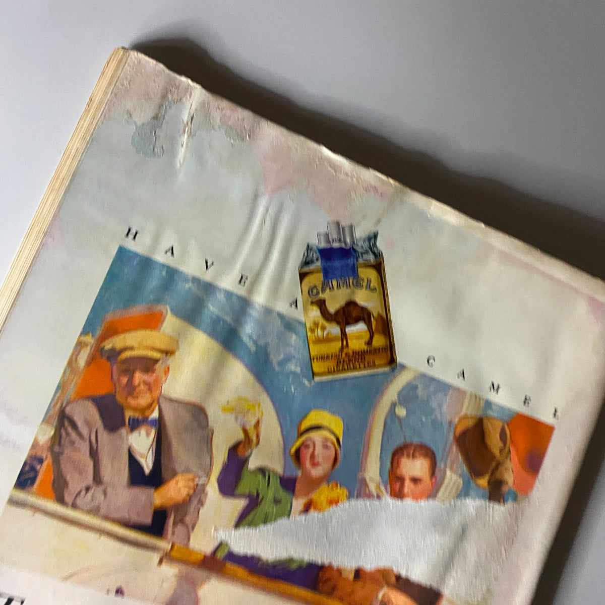 Cover page view of The New Yorker Complete Magazine May 21, 1927 showcasing a partially peeled advertisement for Camel cigarettes, highlighting 1920s graphic design.