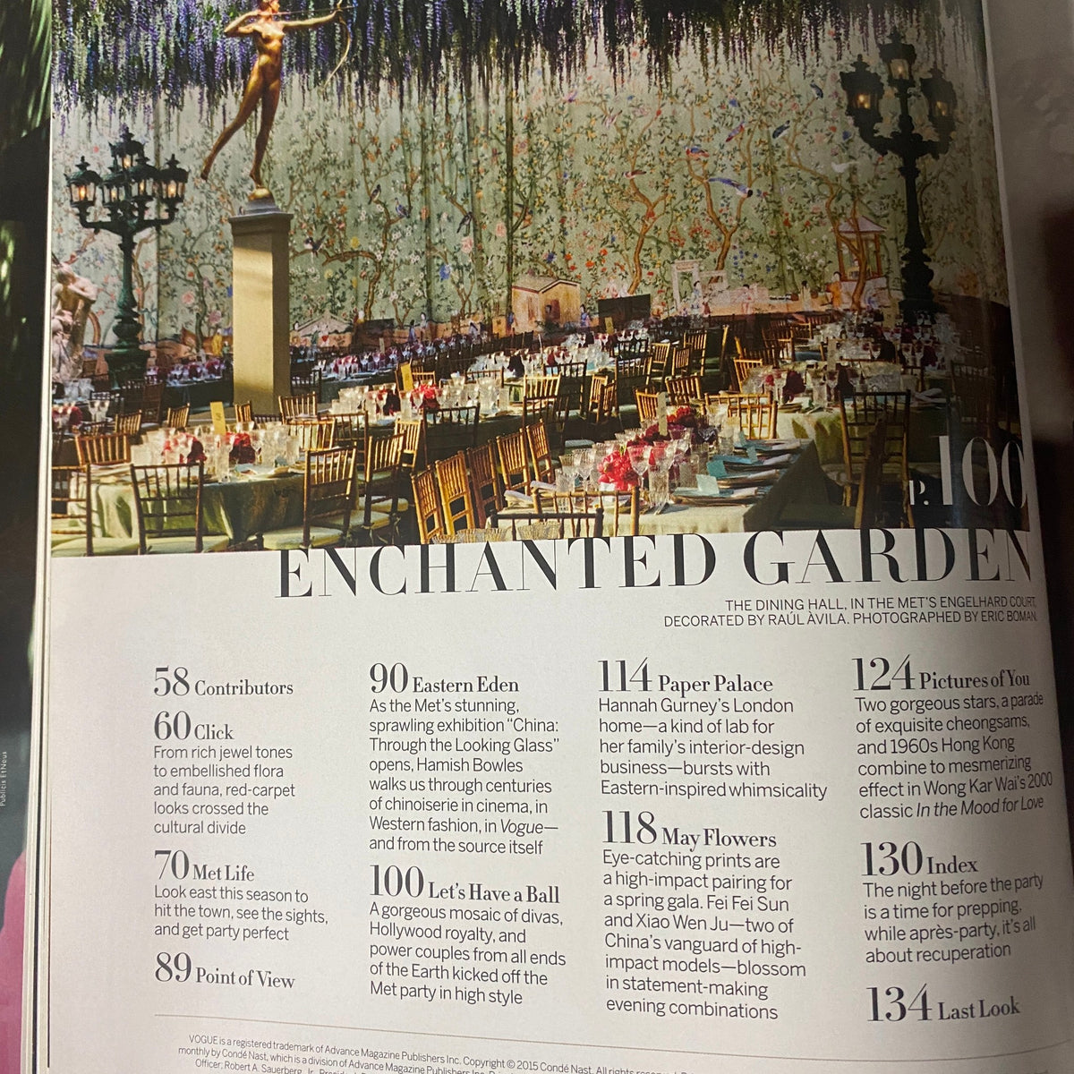 Interior page of Vogue Magazine 2015 featuring the Enchanted Garden layout from the Met Gala, showcasing elegant dining arrangements. Vogue Magazine 2015 Rihanna Cover for Met Gala No Label VG.