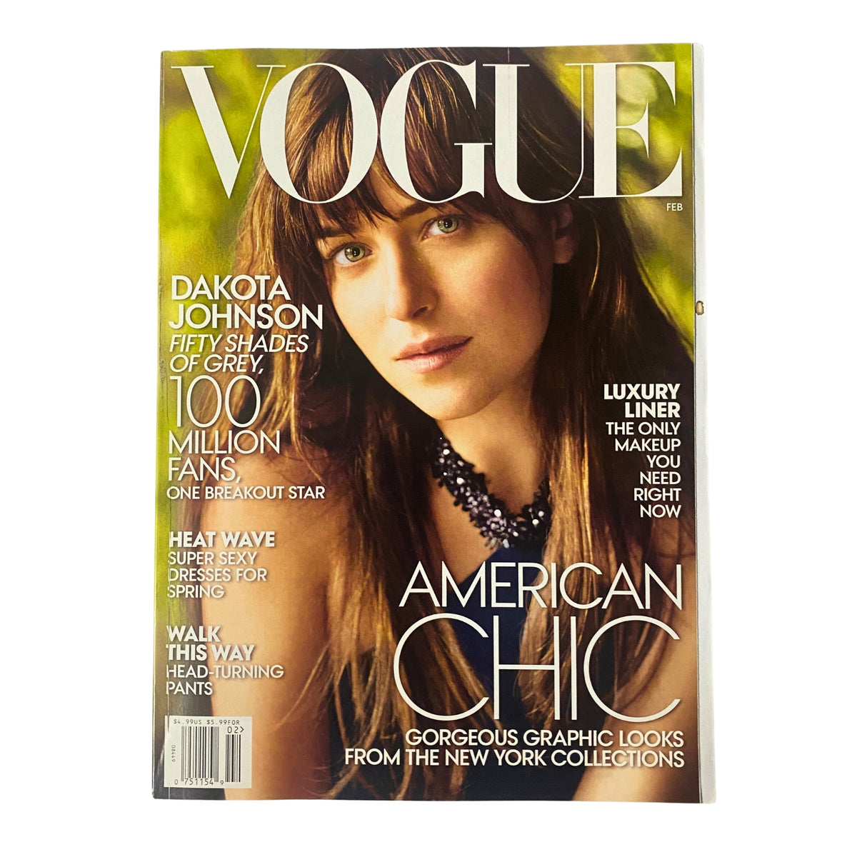 Vogue Magazine February 2015 Dakota Johnson Cover featuring the actress with long hair, showcasing a necklace and the title 'American Chic', highlighting her breakout role in Fifty Shades of Grey.